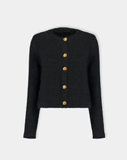 Cardigan tricot preto fotografado em fundo neutro mostrando frente plana e fileira de botões dourados
