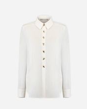 Foto do produto: camisa alongada off-white em fundo branco, vista frontal com botões decorativos e gola pontuda